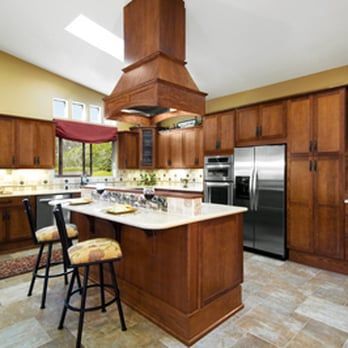 A kitchen with stainless steel appliances and wooden cabinets