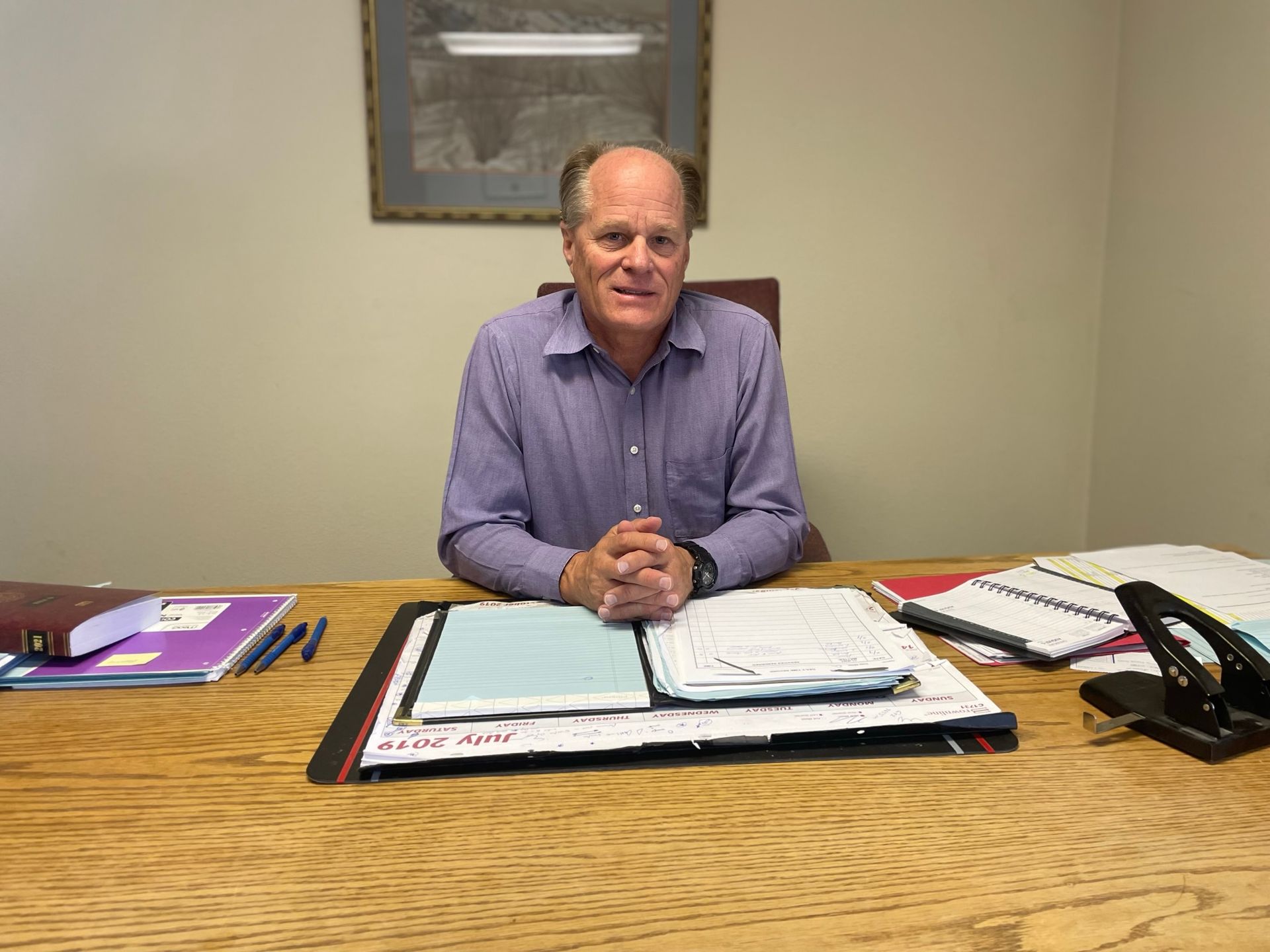 clayton r miller sitting at desk