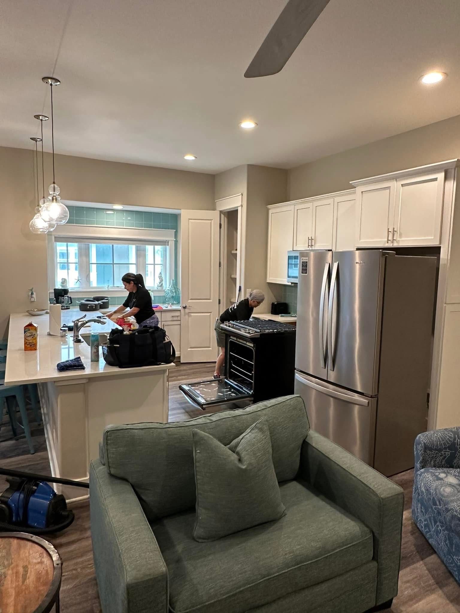 A woman is cleaning the floor with a mop.