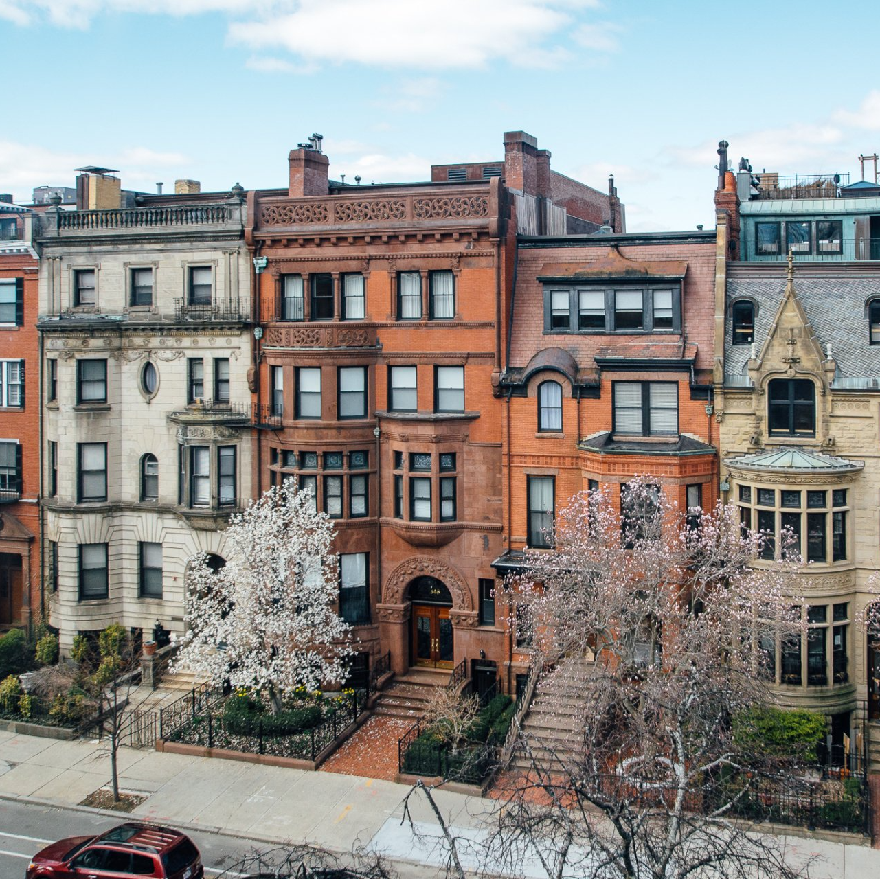 photo of a Boston street with a row of brownstone homes