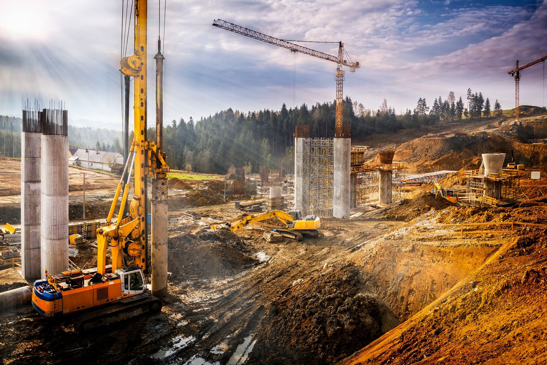 Construction site aerial with cranes and heavy equipment, showcasing crane hire services.