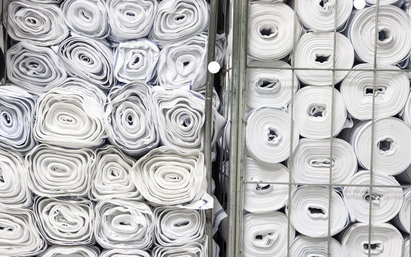 Rolls Of White Fabric Stored In Warehouse — Dallas, TX — Pacific Rope and Tarp Company