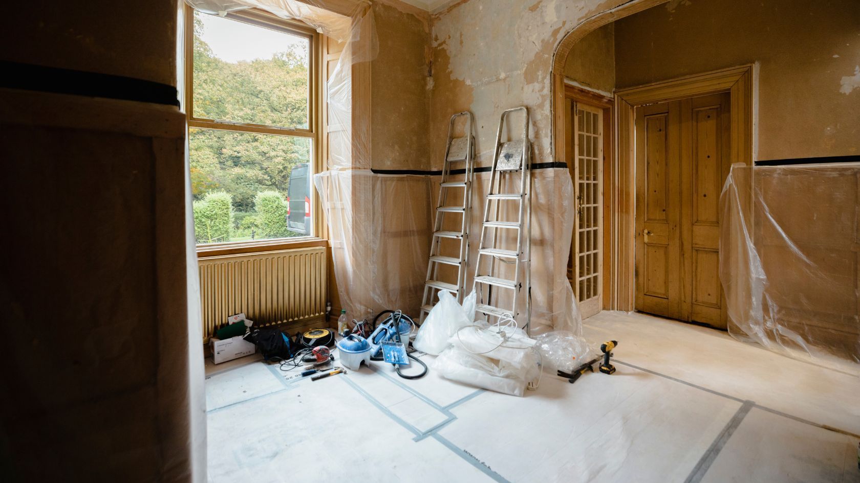 A bathroom with two sinks , a toilet and shelves.