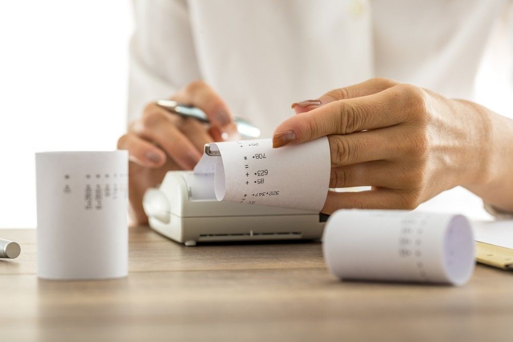 A Person is Taking a Receipt From a Cash Register — Eacham Accounting and Audits in Cassowary Coast, QLD
