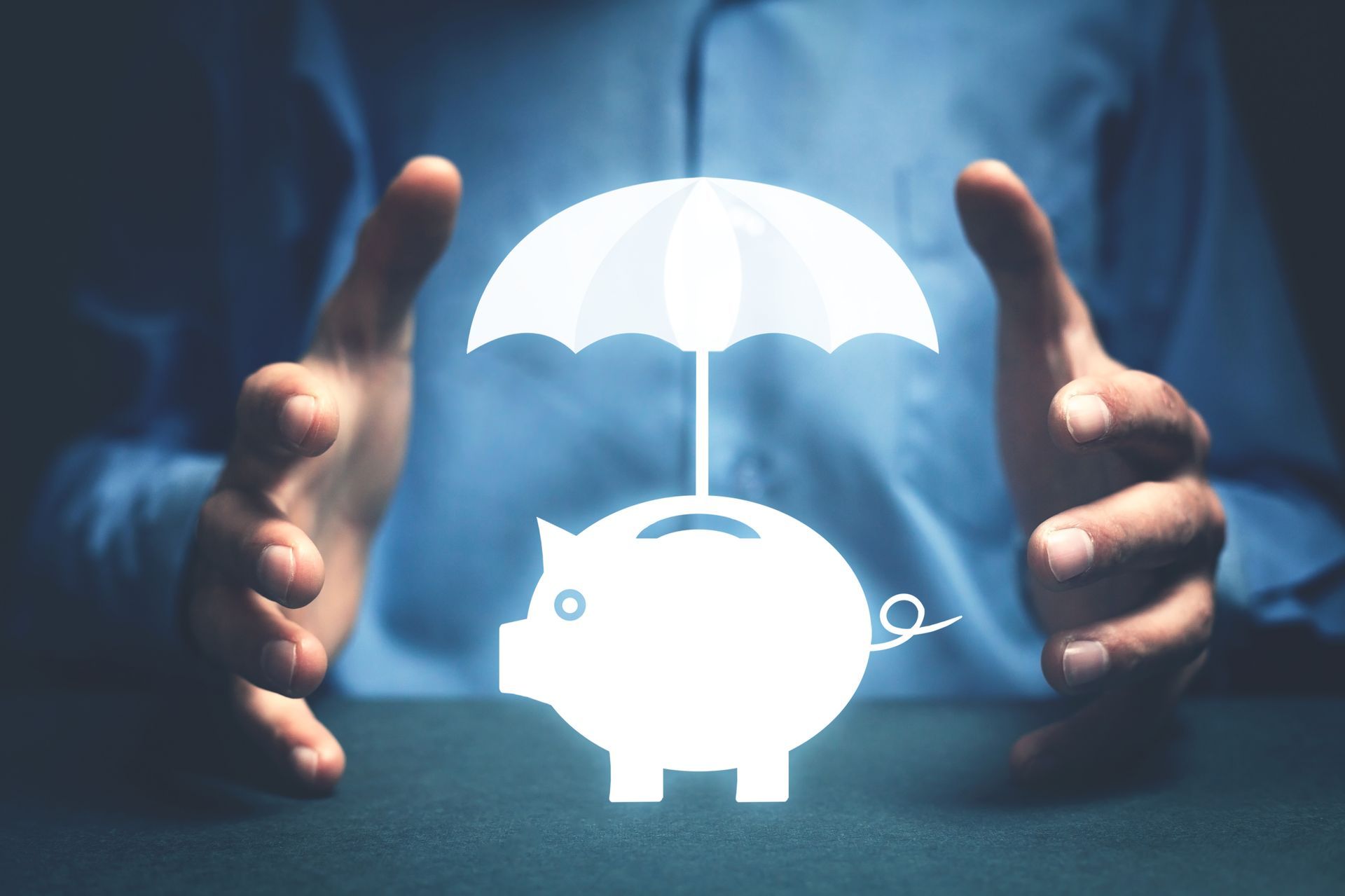 Hands protecting a glowing piggy bank under an umbrella, symbolizing financial protection.