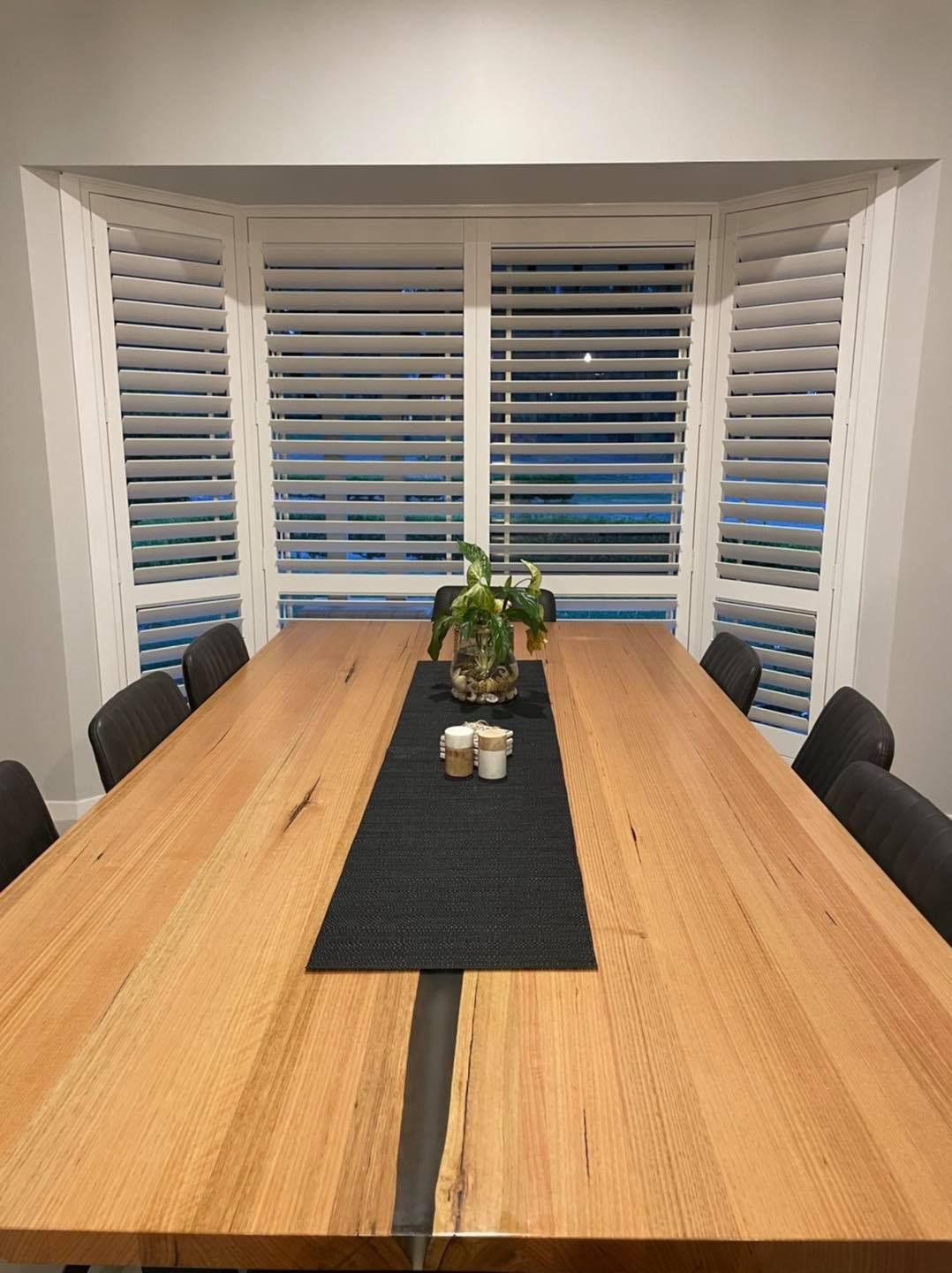 A Long Wooden Table With a Black Table Runner in a Dining Room — Elegant Blinds & Awnings in Forster, NSW