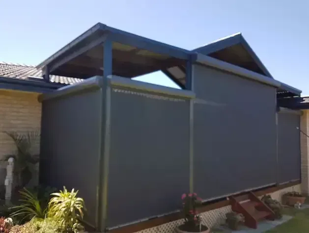A House With a Covered Porch and a Shed on the Side of It — Elegant Blinds & Awnings in Forster, NSW