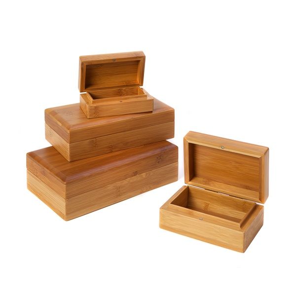 Four wooden rectangular boxes, some opened, stacked, and arranged on white surface.