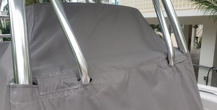 Gray cushioned seat cover on a metal-framed chair in an outdoor setting