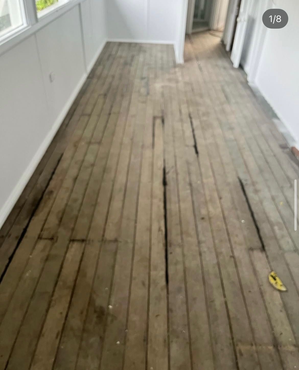 Old, damaged wooden floor in a room with white walls. — Tweed Coast Cork & Timber Floors In Tweed Heads, NSW