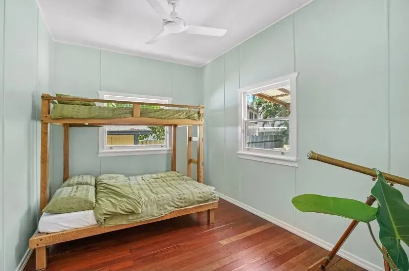 A Bedroom With a Bunk Bed and a Ceiling Fan — Tweed Coast Cork & Timber Floors In Tweed Heads, NSW