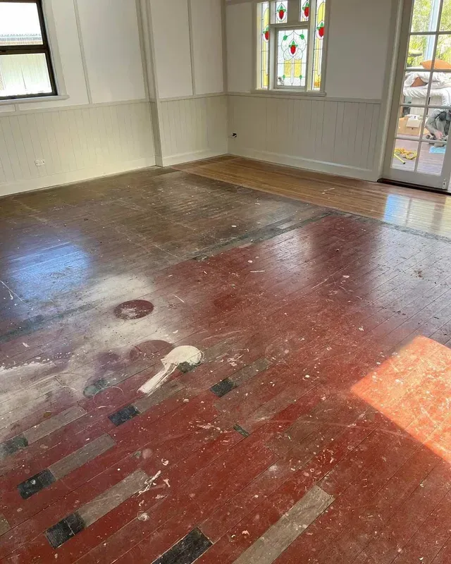 A Room With a Red Floor and White Walls — Tweed Coast Cork & Timber Floors In Tweed Heads, NSW