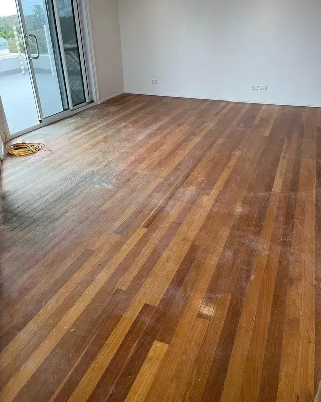 A Room With a Wooden Floor and a Sliding Glass Door — Tweed Coast Cork & Timber Floors In Tweed Heads, NSW