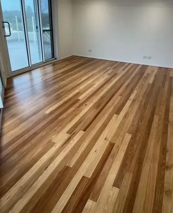 A Living Room With a Wooden Floor and a Clear Sliding Glass Door — Tweed Coast Cork & Timber Floors In Tweed Heads, NSW