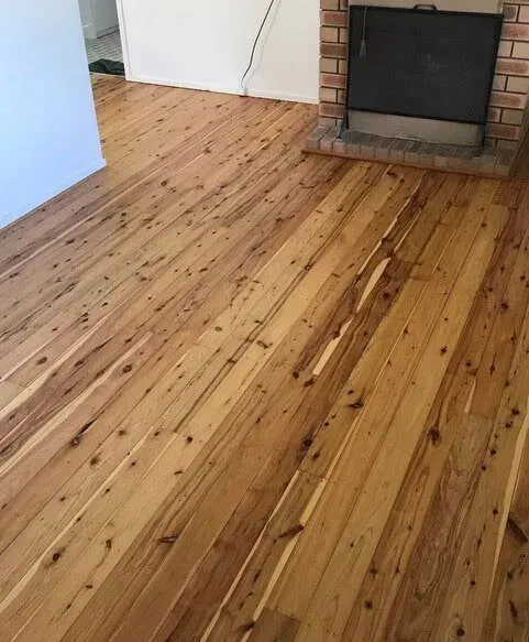 A Living Room With a Wooden Floor and a Fireplace — Tweed Coast Cork & Timber Floors In Tweed Heads, NSW