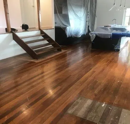A Wooden Floor in a Room With Stairs and a Sink — Tweed Coast Cork & Timber Floors In Tweed Heads, NSW