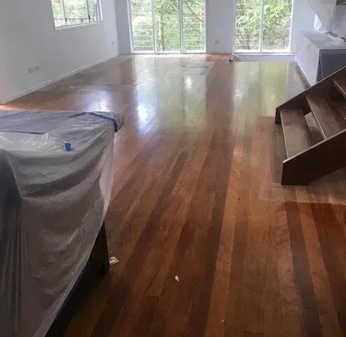 A Living Room With Hardwood Floors and Stairs — Tweed Coast Cork & Timber Floors In Tweed Heads, NSW