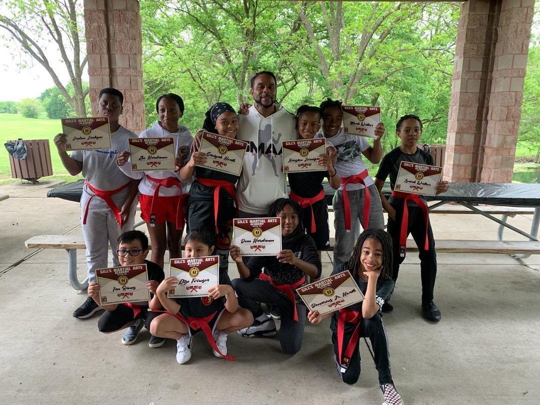 A group of children are posing for a picture while holding certificates.
