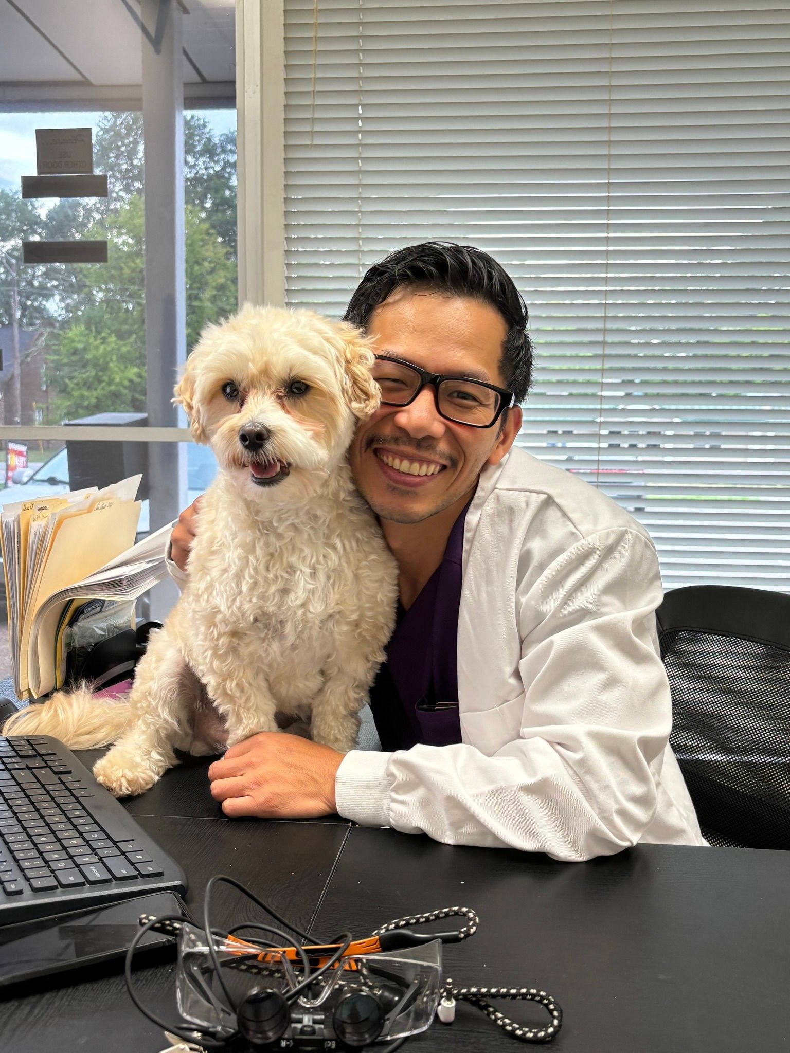 Dr. Ta is sitting at a desk with a Watson. 