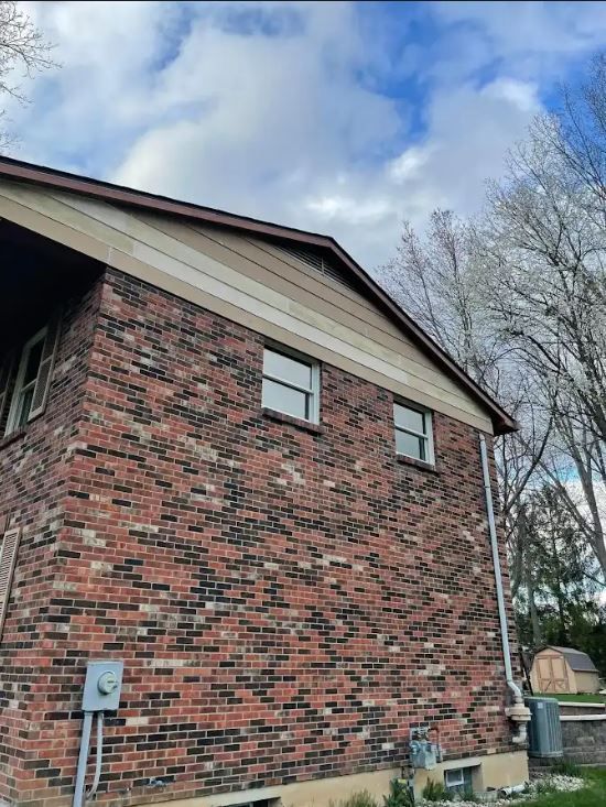 A row of buildings in a small town with cars parked in front of them