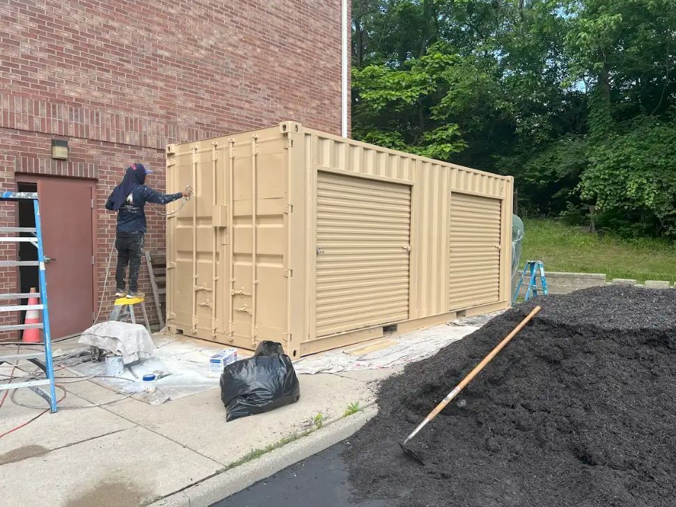 A row of buildings in a small town with cars parked in front of them