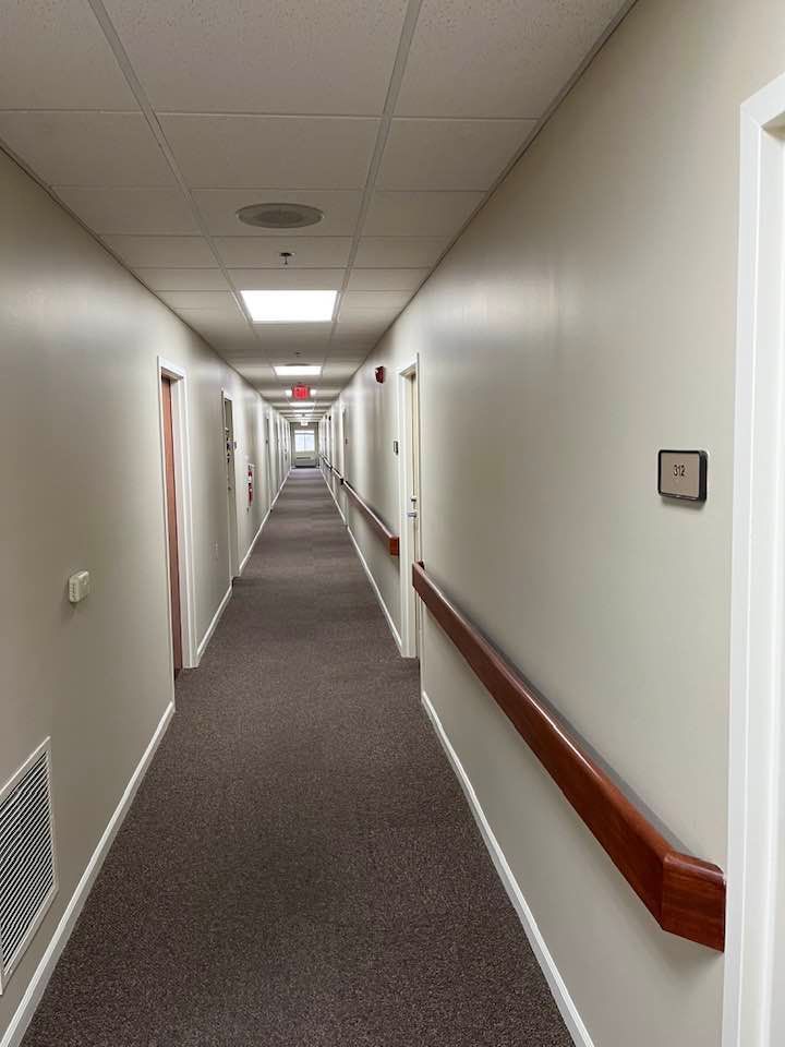 A long hallway with a sign on the wall that says ' a ' on it
