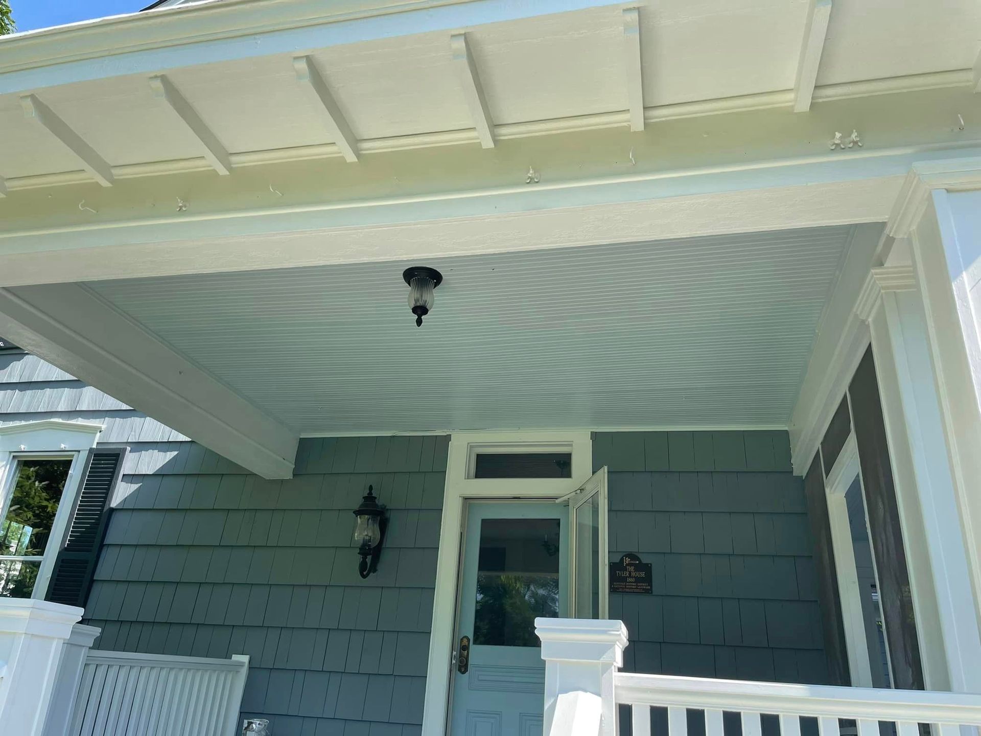 The front porch of a house has a light on it