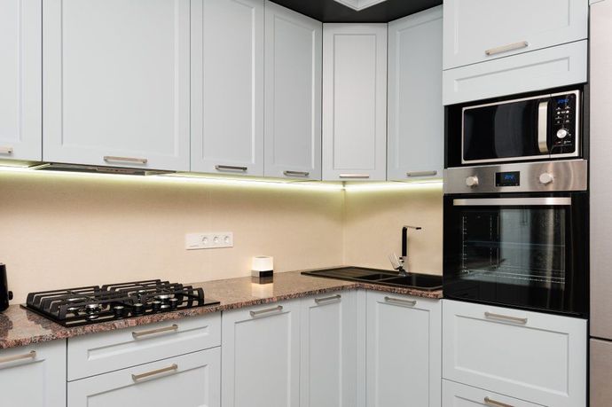 A Kitchen with White Cabinets, a Stove Top Oven, a Microwave, and A Refrigerator — Bestbuy Kitchens in Yandina, QLD