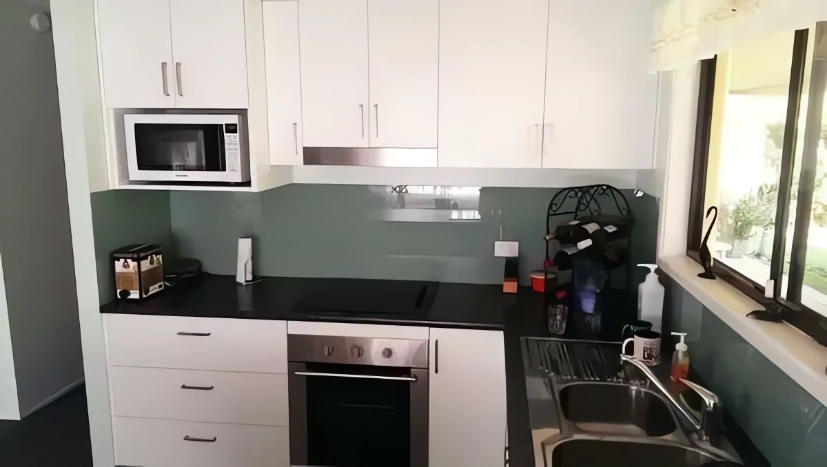 A Kitchen with Stainless Steel Appliances and White Cabinets — Bestbuy Kitchens in Yandina, QLD