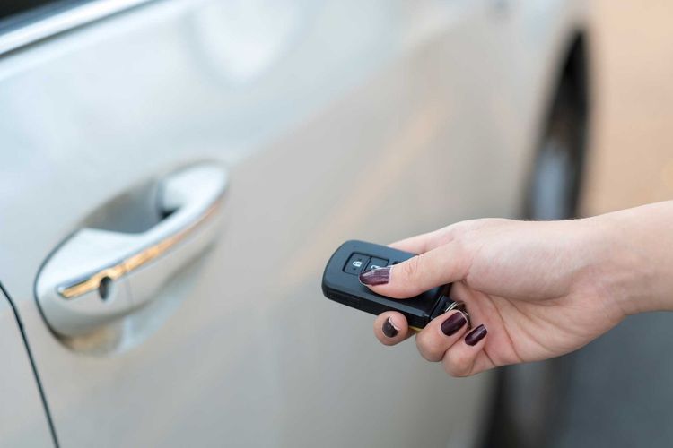 Woman Using Remote on Her Car