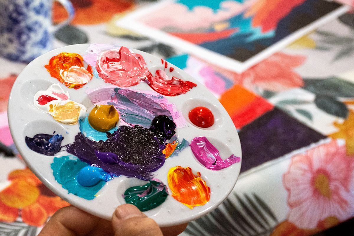 Person mixing paint on palette | NDIS Painting Classes by Spotty Dog Studios on the Gold Coast