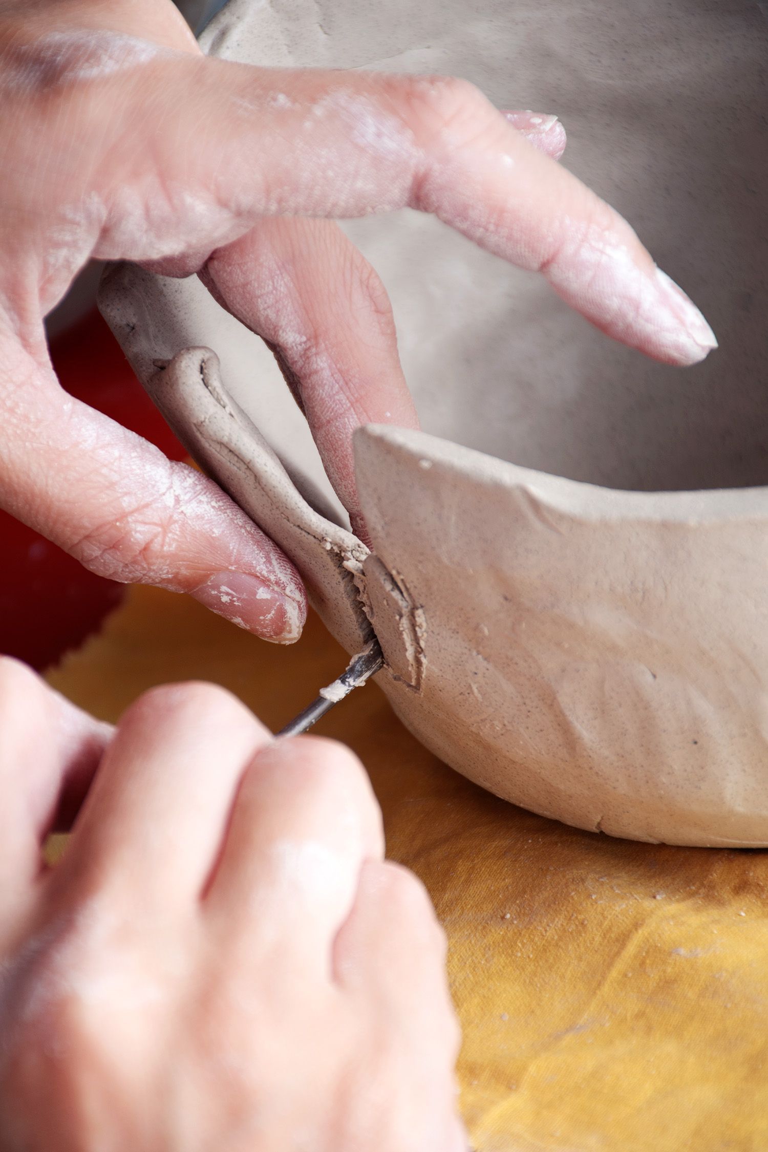 hands sculpting bowl out of clay | NDIS Pottery Classes by Spotty Dog Studios on the Gold Coast