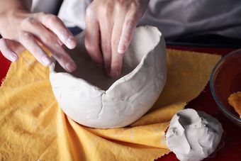 Hands shaping a bowl out of air dry clay | NDIS Pottery Classes by Spotty Dog Studios on the Gold Coast