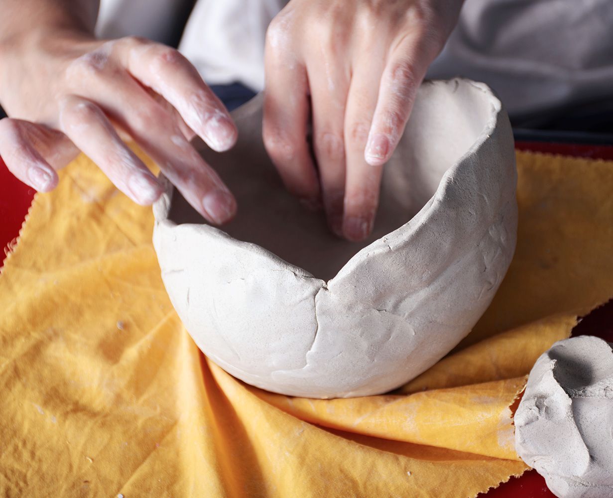 Hands shaping a bowl out of air dry clay | NDIS Pottery Classes by Spotty Dog Studios on the Gold Coast