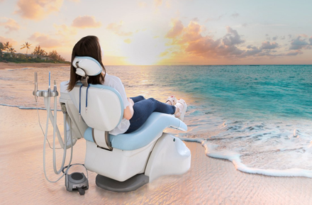 Woman sitting in dental chair on beach