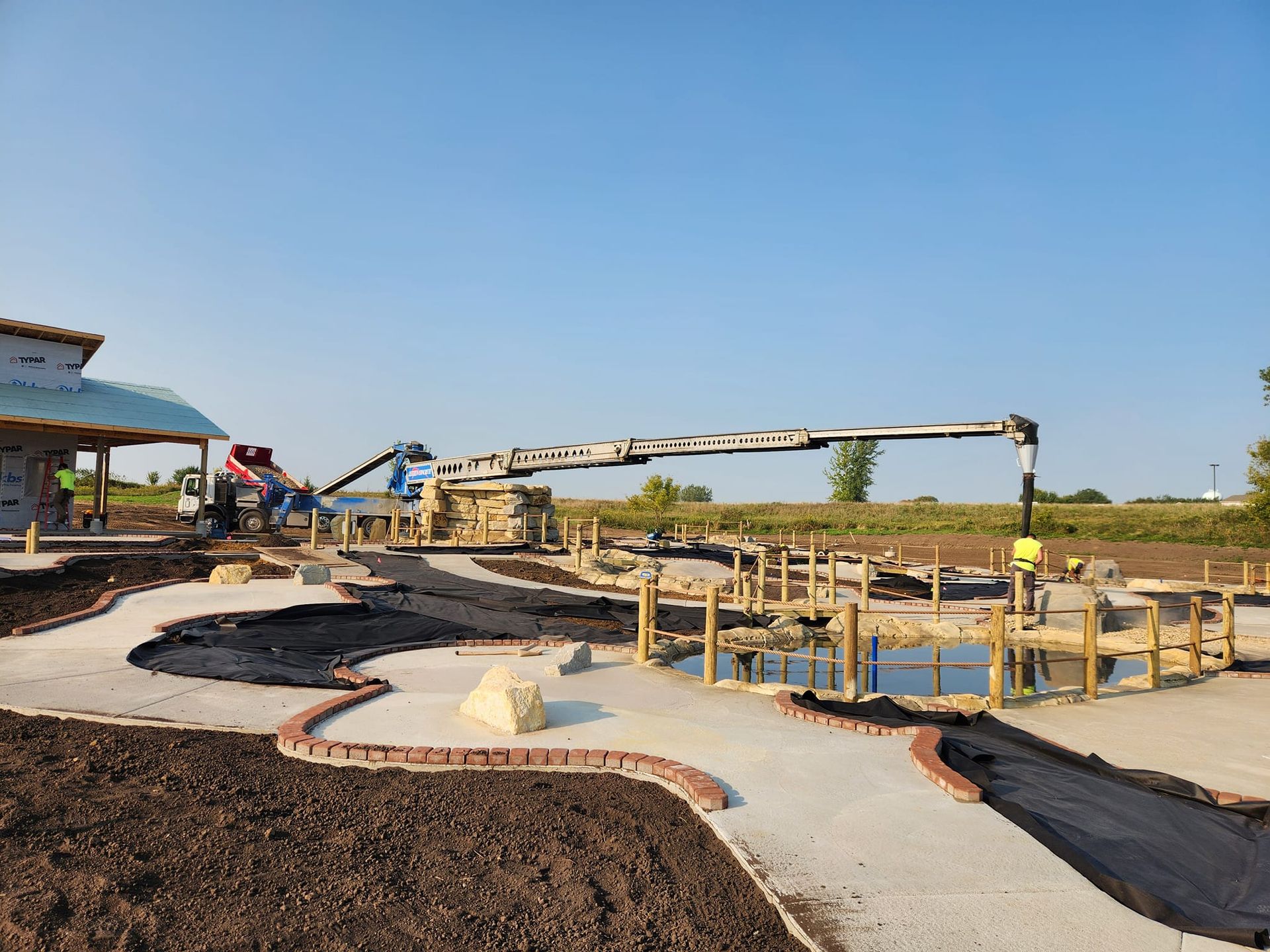 A concrete pump is being used to pour concrete into a pool.