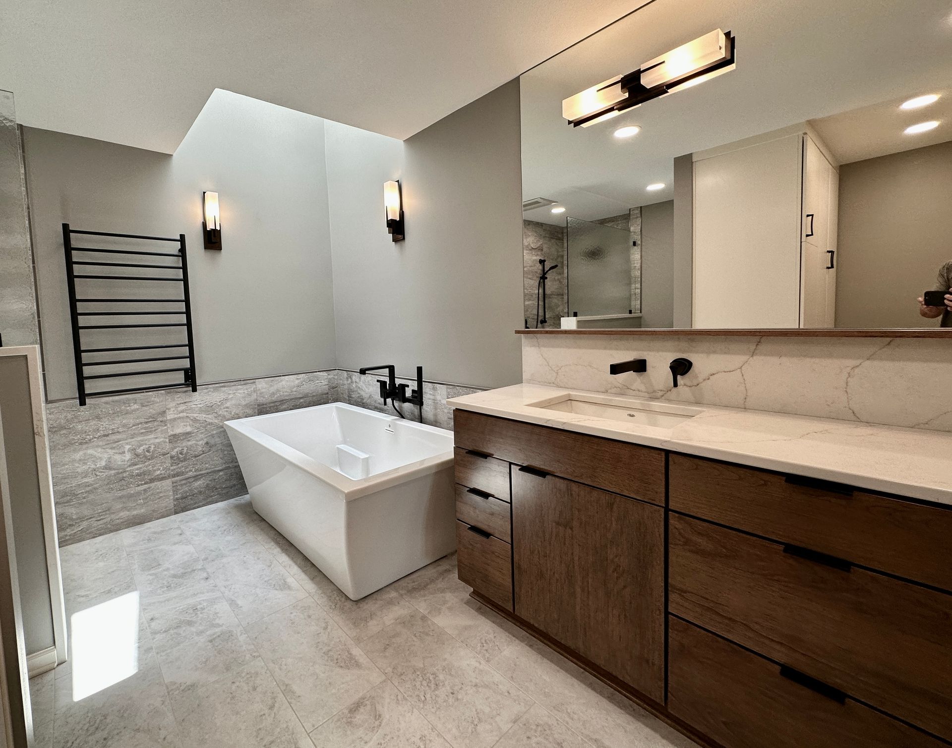 a bathroom remodel with two sinks and a bathtub