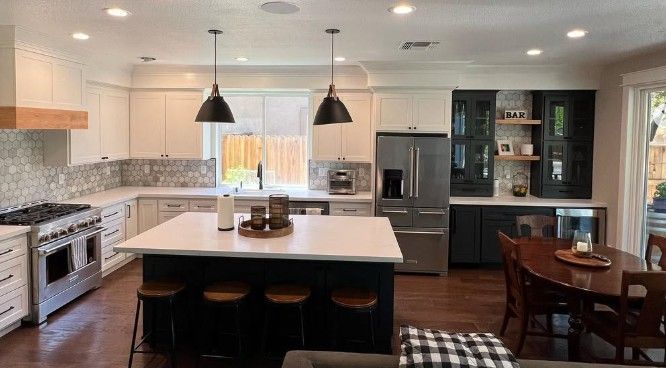 Two men are working on the roof of a house under construction.