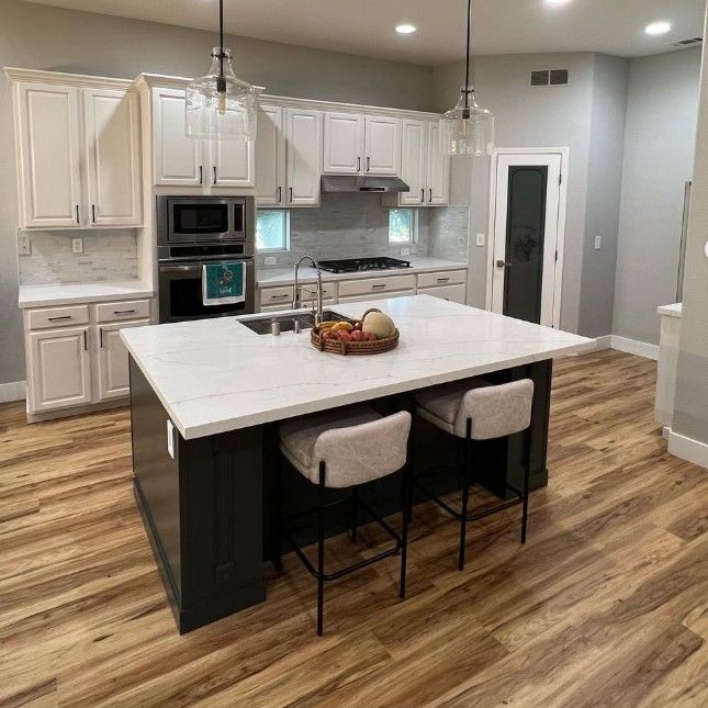 There is a large island in the middle of the kitchen.