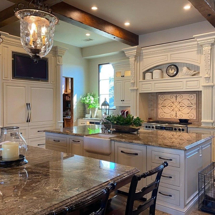A kitchen with white cabinets and granite counter tops
