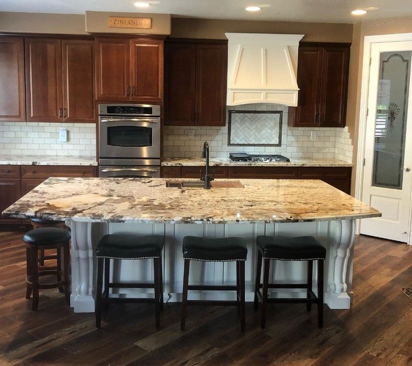 A kitchen with a large island and stools