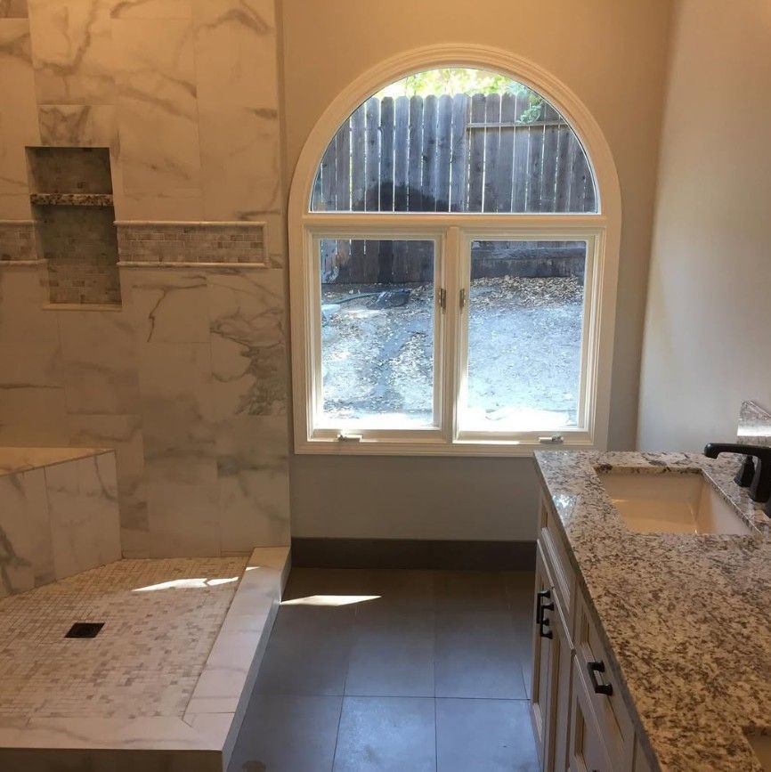 A bathroom with a large window and a sink