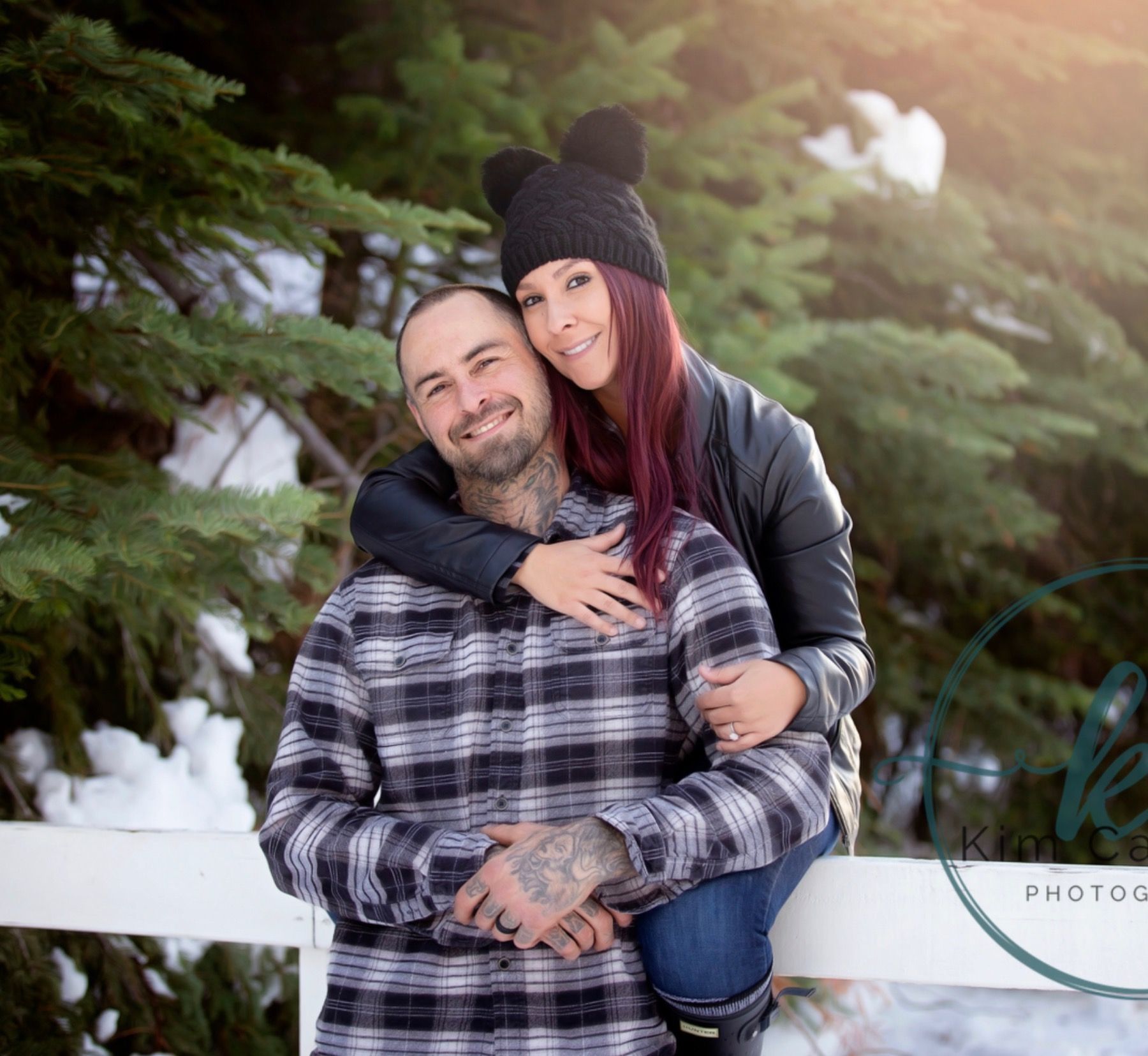Two men in suits and ties are standing in front of an american flag.