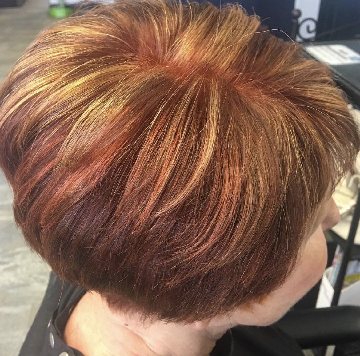 A close up of a woman 's hair with highlights