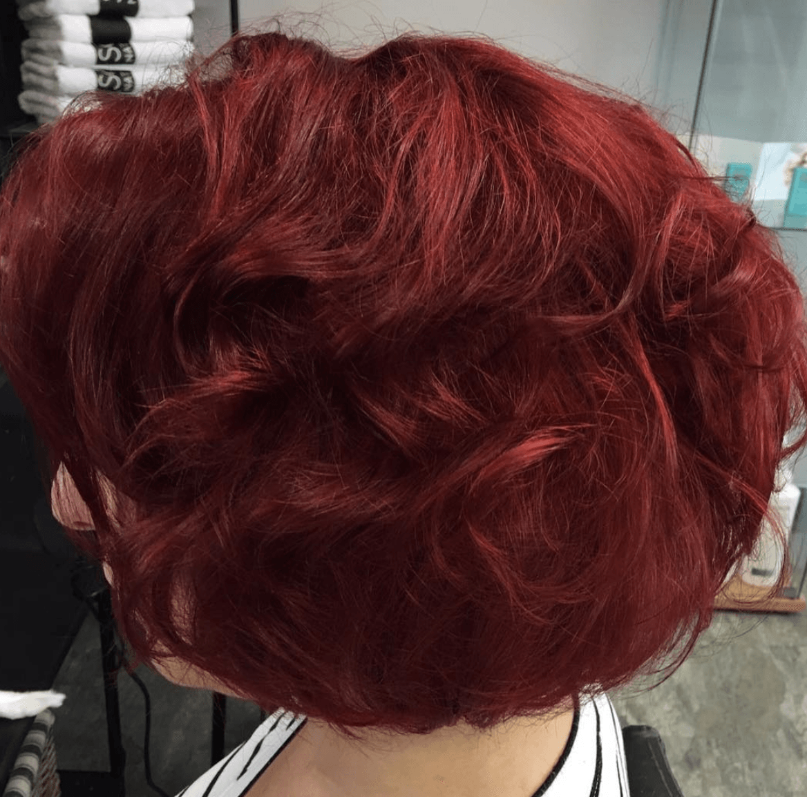 A woman with red hair is sitting in a chair