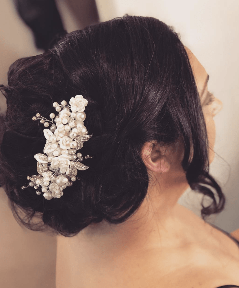 A woman wearing a bun with flowers in her hair