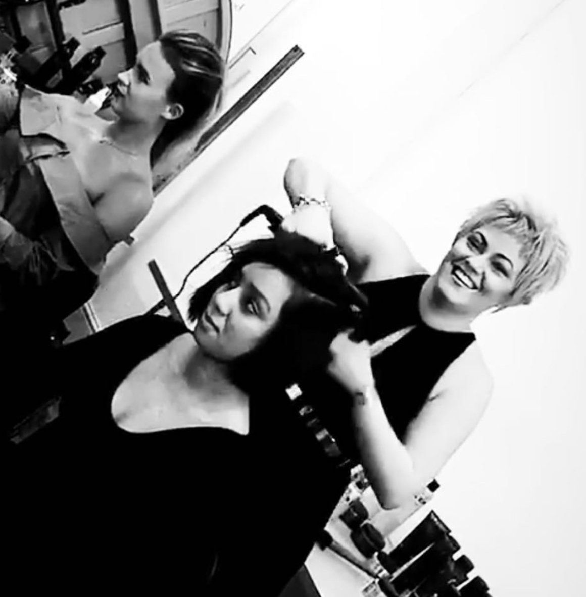 A black and white photo of two women and a man