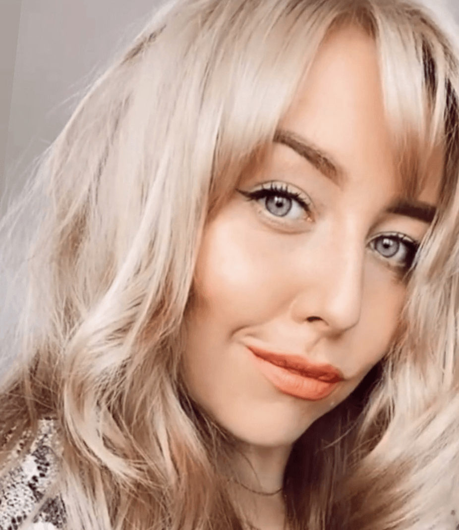 A close up of a woman 's face with blonde hair and blue eyes.