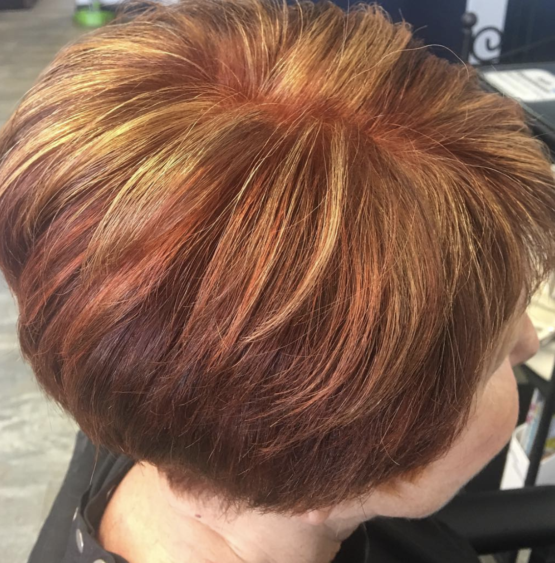 A close up of a woman 's hair with highlights