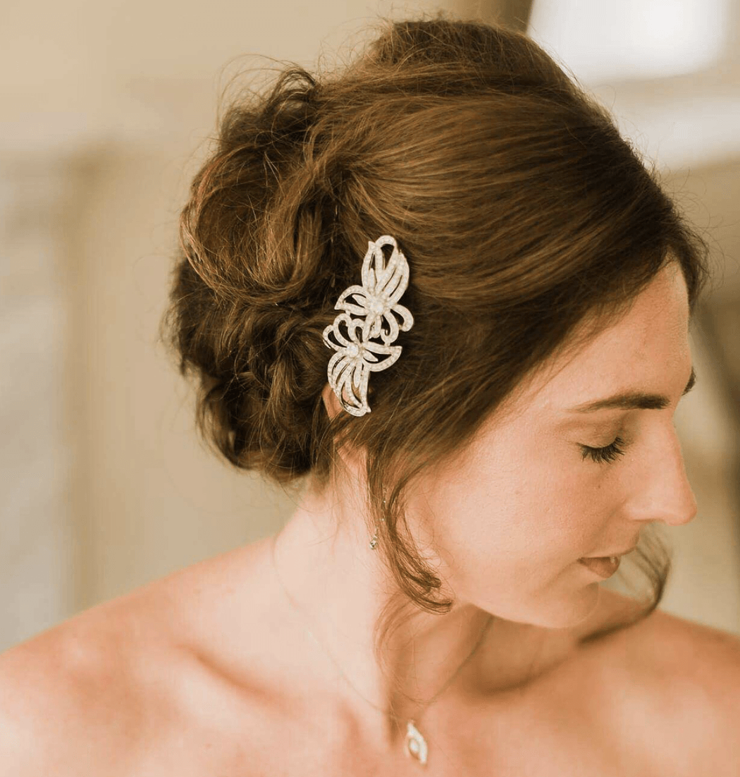 A woman is wearing a hair clip in her hair.